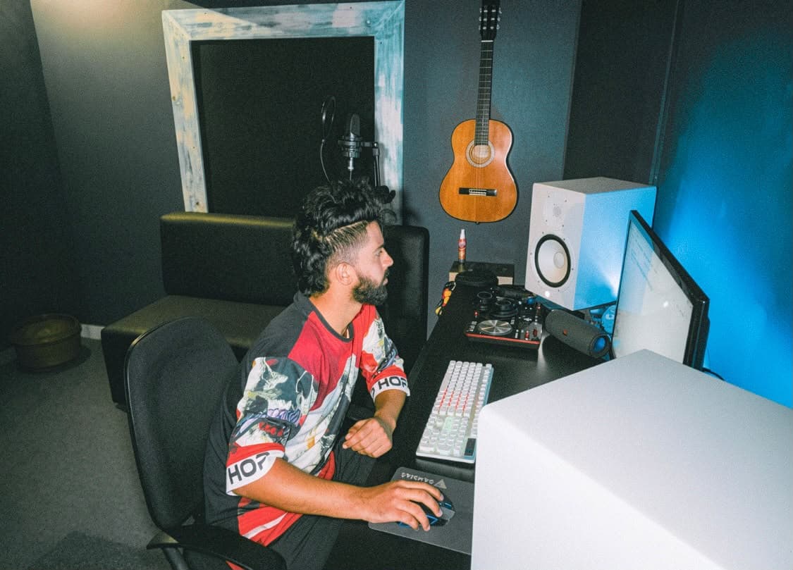 Producer working on music at the studio desk