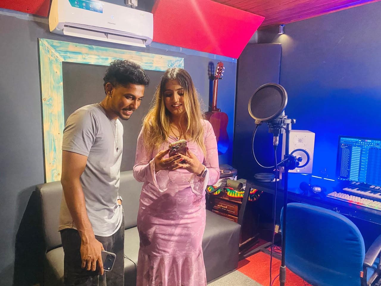 Two artists working together at the vocal microphone